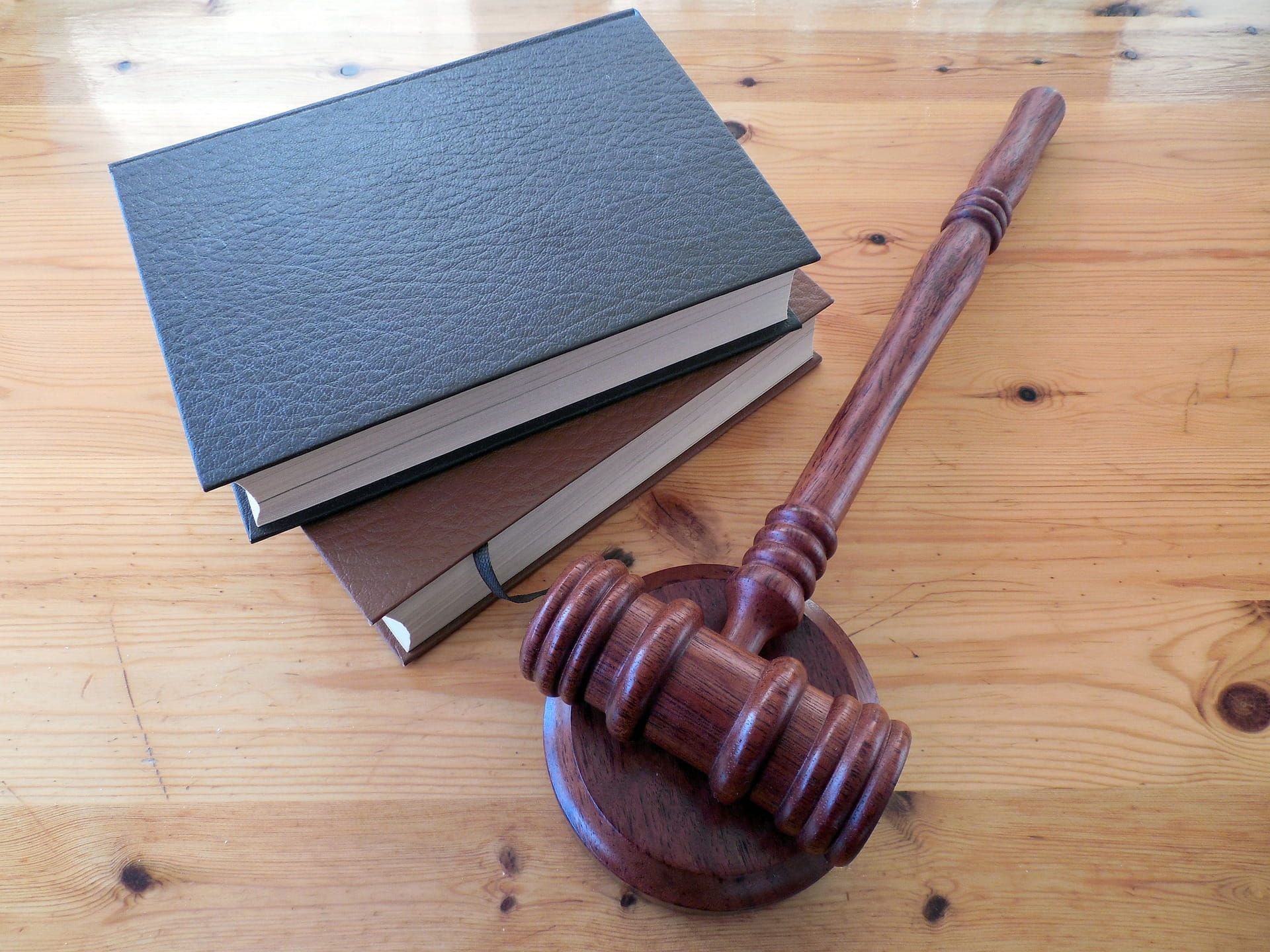 A picture of law books with a hammer and gavel