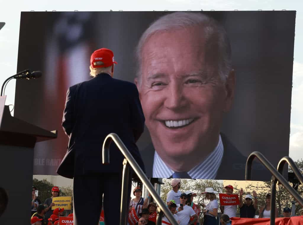 Former U.S. President Donald Trump watches a video of President Joe Biden playing during a 2022 rally in Miami.