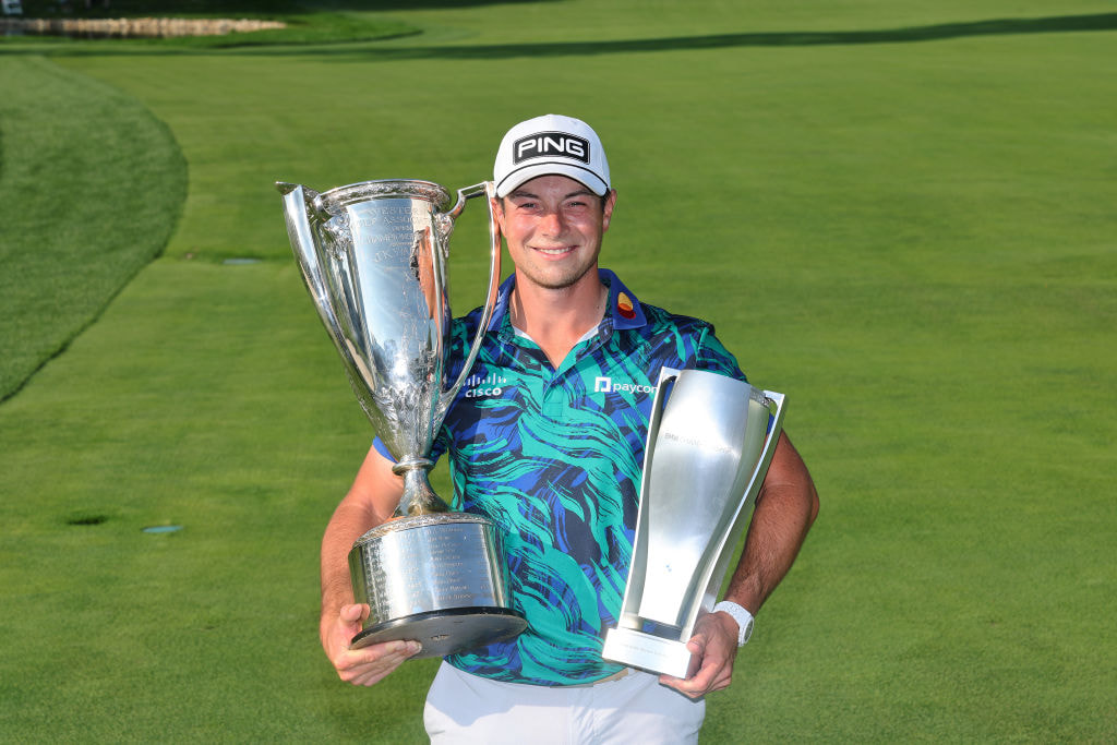 Viktor Hovland shows off some of his winning trophies. 