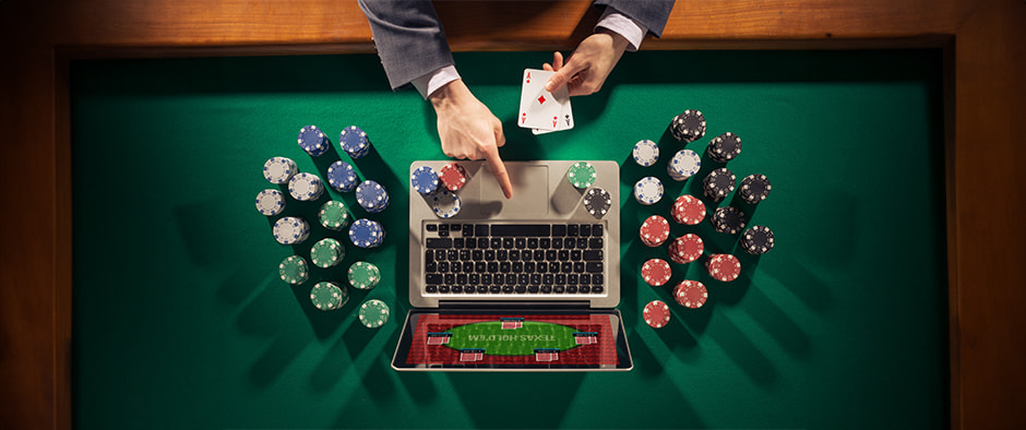 This image features a person engaging in online gambling using a laptop placed on a casino table. The laptop screen displays an online poker interface, suggesting the user participates in an online gambling game. The person is wearing a suit and is in the process of dealing playing cards onto the laptop, blurring the line between physical and digital gaming. Around the laptop, various colored casino chips are neatly arranged, indicating the stakes involved. The table surface is covered in a typical casino-style green felt, enhancing the gambling atmosphere. The overall setup illustrates the merging of traditional and online gambling environments.