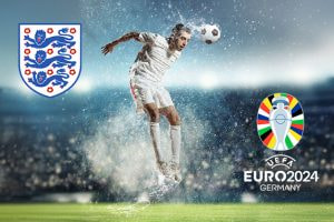 A football player in a white kit heading a ball on a wet pitch with water splashing around him. The England national team logo is on the left, and the UEFA Euro 2024 Germany logo is on the right. The background shows a stadium filled with spectators under a night sky.