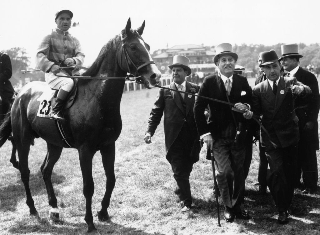 Champion jockey Gordon Richards being led in after winning the 1953 Derby on 'Pinza'. 