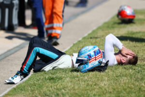 Logan Sargeant looks dejected after retiring from a Formula 2 Championship race in France.