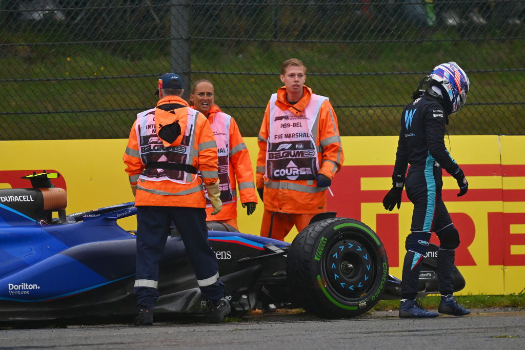 Logan Sargeant walks from his car after stopping on track during a practice session for the 2023 Grand Prix of Belgium. 