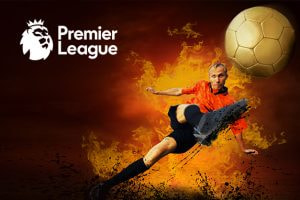 This image depicts a football player in an orange kit kicking a ball, with a fiery background symbolising intensity and action. The Premier League logo is prominently placed in the top left corner, with the golden football in mid-air, representing the league’s elite level of competition. The scene evokes energy and power, with the player making a dynamic move as sparks fly around, emphasising the passion of Premier League football.