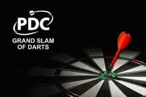 Red dart hitting the bullseye on a dartboard with the PDC Grand Slam of Darts logo in the background