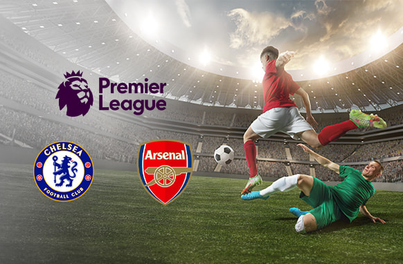 Premier League match between Chelsea and Arsenal with team logos, showing a dramatic scene of a player in red taking a shot on goal as a defender in green slides in to block, set against a packed stadium background.