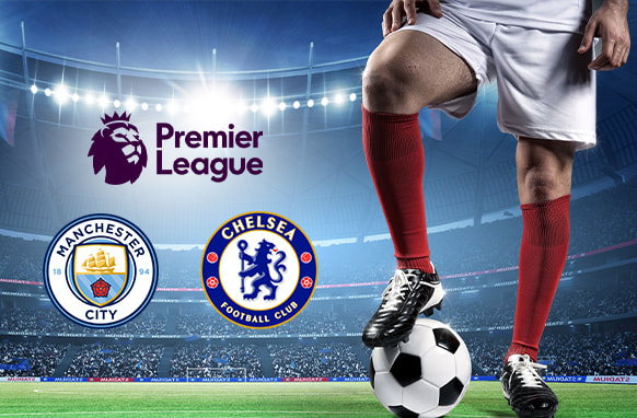 A football player in red socks stands on a vibrant green pitch with a ball, under bright stadium lights. The image prominently features the Manchester City and Chelsea crests alongside the Premier League logo, highlighting their upcoming match in the tournament.