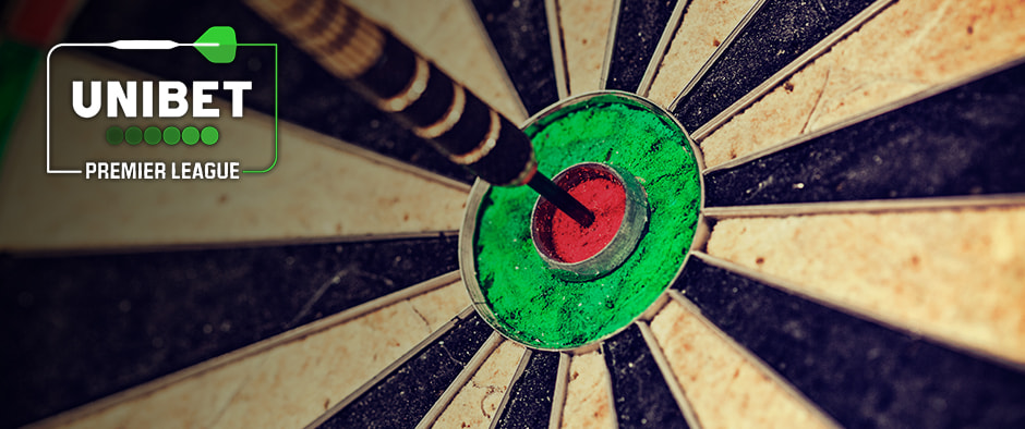  Close-up image of a dartboard focusing on a dart perfectly hitting the red bullseye. The Unibet Premier League logo is visible in the upper left corner, featuring a green dart graphic and the company's name. The dartboard's radial segments are clearly visible, highlighting the accuracy of the throw.