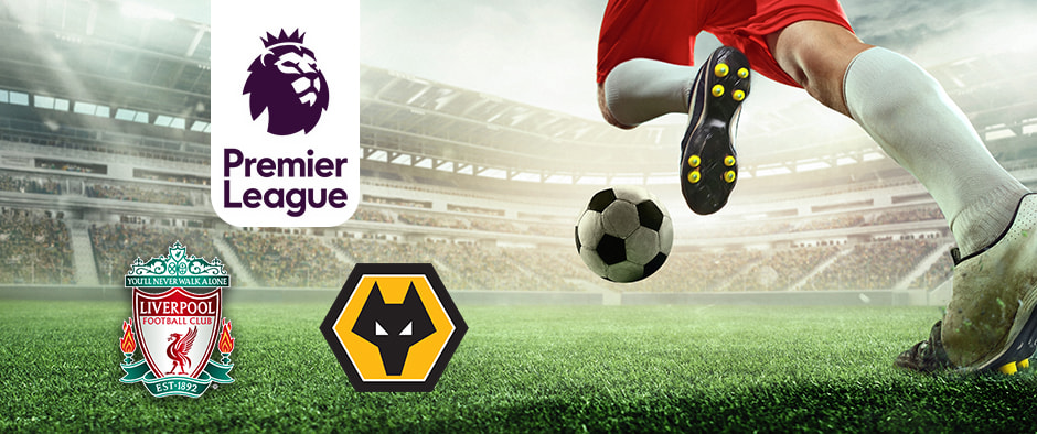 An action-packed football scene in a stadium with a player in red shorts and white socks about to kick a soccer ball on the grass. The Premier League logo is displayed on the left, alongside the logos of Liverpool Football Club and Wolverhampton Wanderers (Wolves) Football Club, highlighting their upcoming match in front of a filled audience.